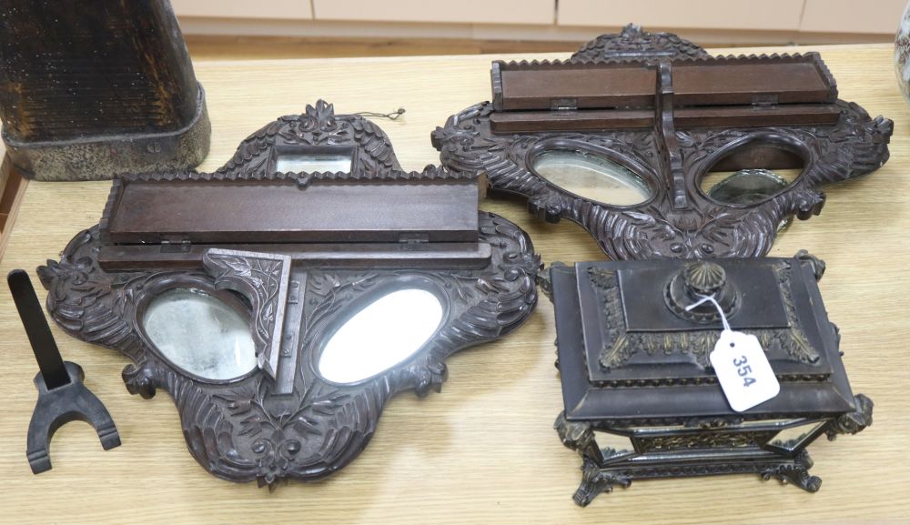 A pair of carved oak mirrored backed wall shelves, together with a mirrored casket